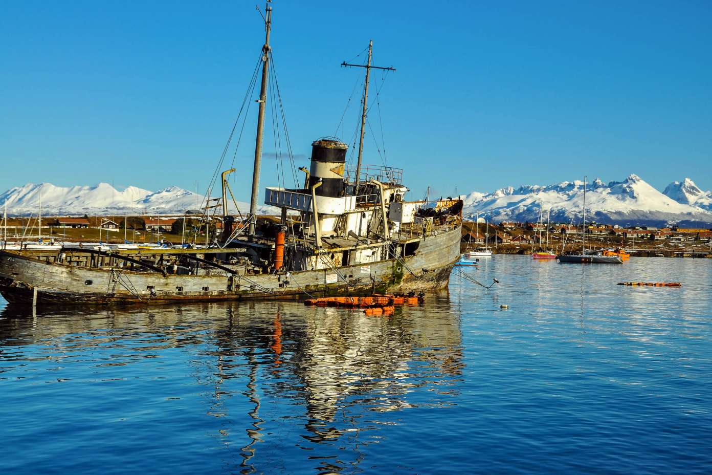 2023/08/chile-altes-boot-mit-den-bergen-von-feuerland-im-hintergrund-chile-jess-kraft-shutterstock-696x464-2x